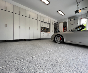 Custom White Garage Cabinets, Slatwall and Garage Flooring in Denver with a Porsche 911 Inside Garage